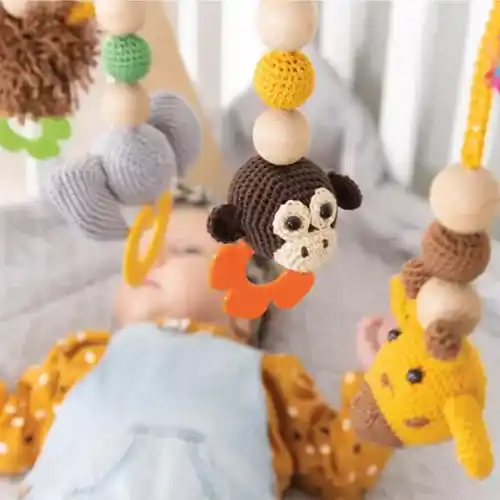 Baby gym with four crochet animal toys